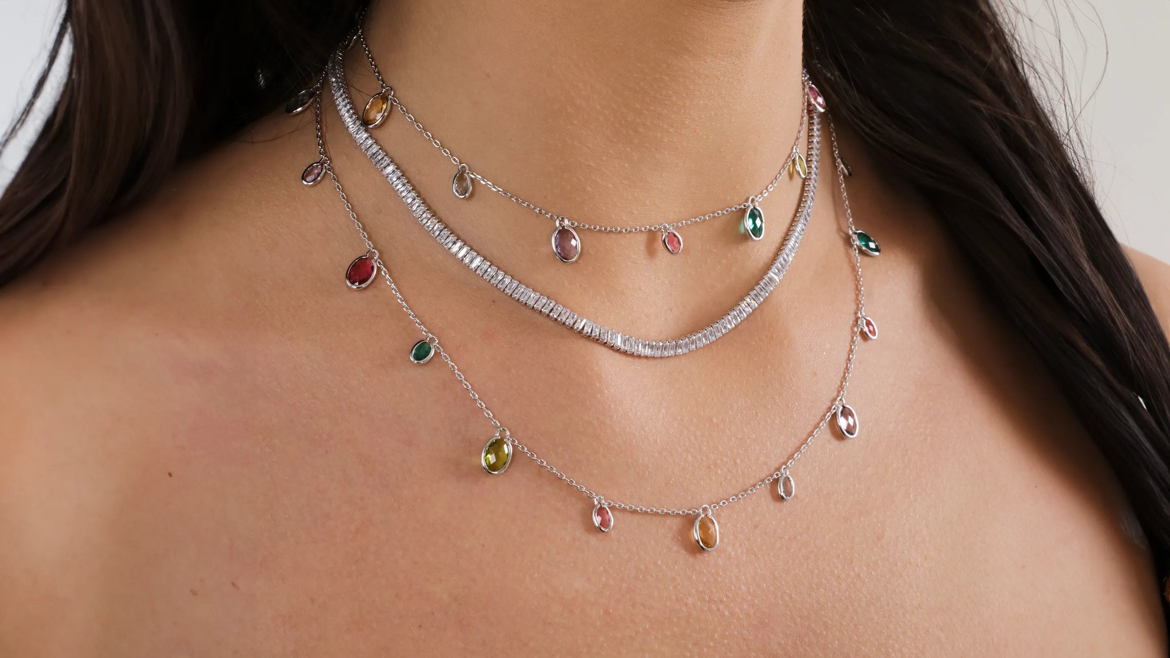 Model wearing Elladora's layered silver necklaces, combining timeless elegance and modern sensibility.