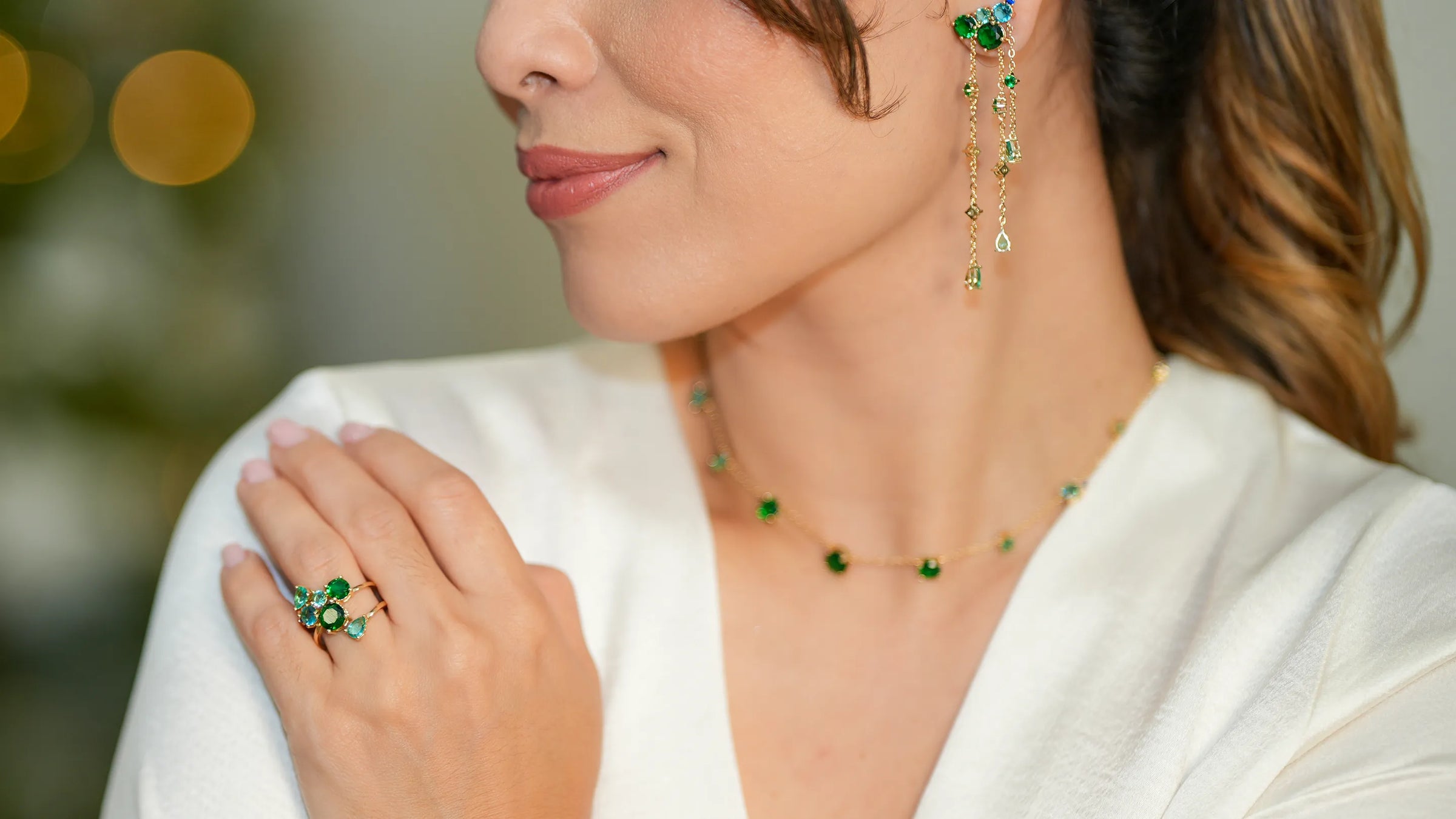 Side view of a woman wearing Elladora's signature fusion stone earrings, adding a pop of color and sparkle to her refined look with eco-conscious elegance.