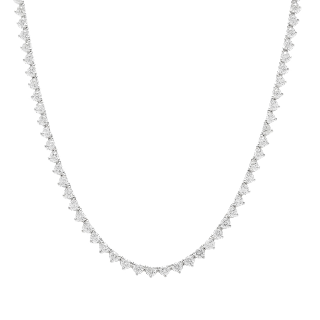 Silver tennis necklace with small moissanite on a white background
