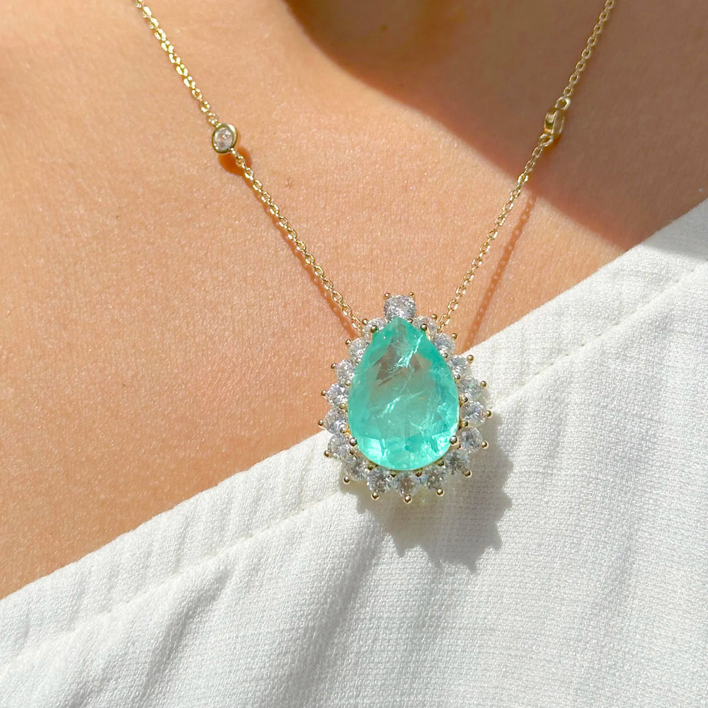 Woman wears Teardrop Colombian emerald pendant necklace with white zirconia 18k gold filled Elladora Store Australia