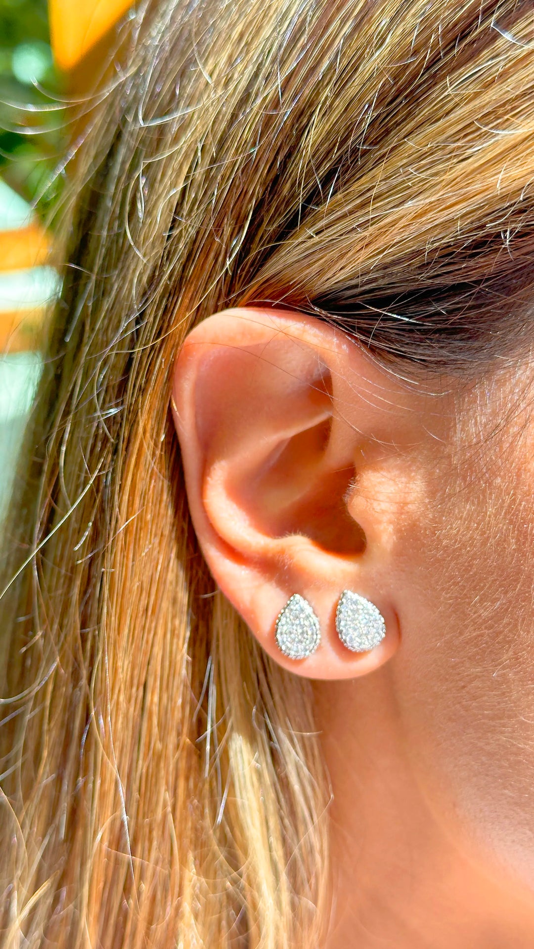 Woman wears bright drop with white cubic zirconia stud earrings 925 Sterling Silver Elladora Store Australia 