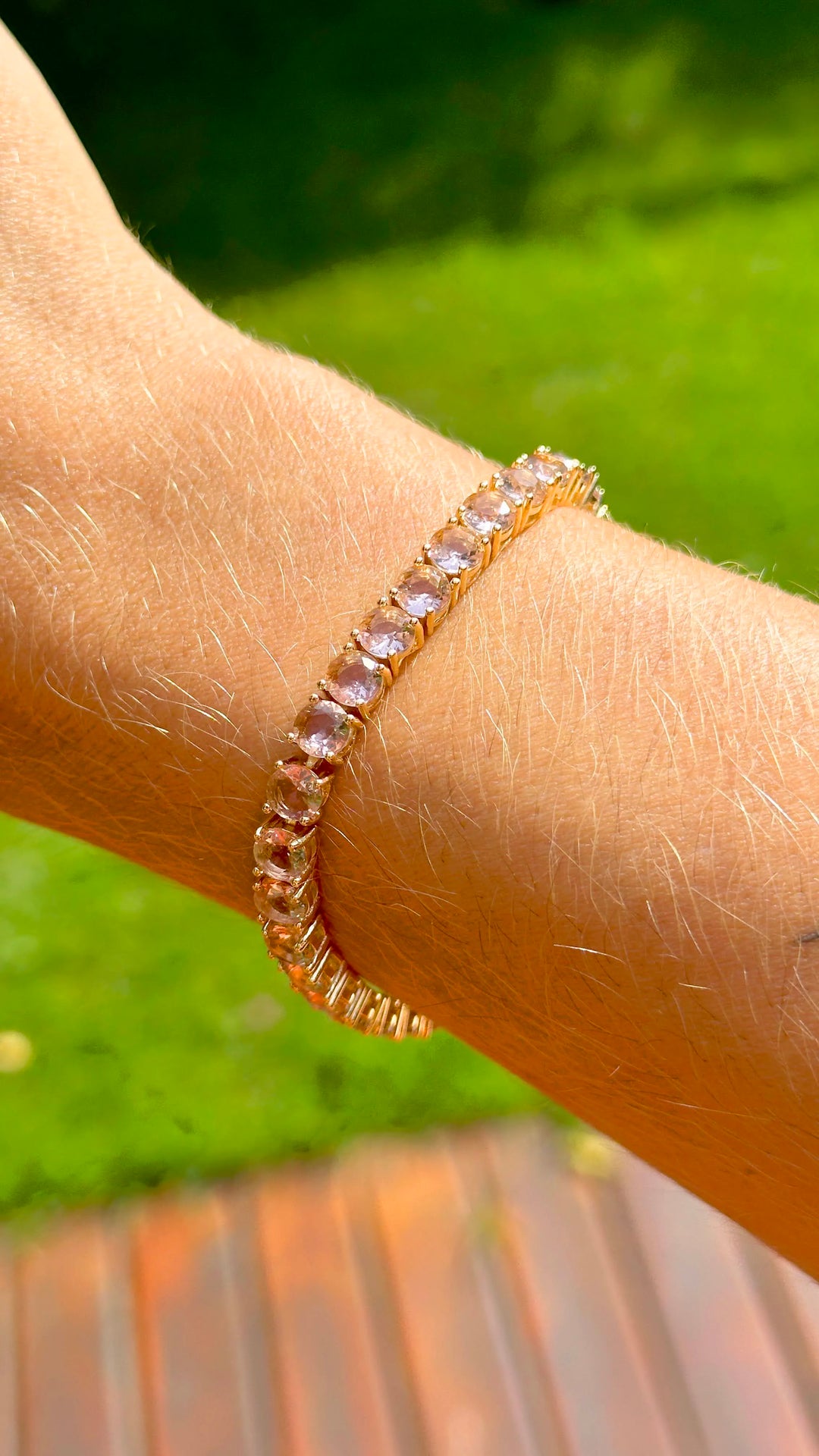 Woman wears Bright Round Rhodolite Crystal Tennis Bracelet, 18k Gold Filled Elladora Store Australia