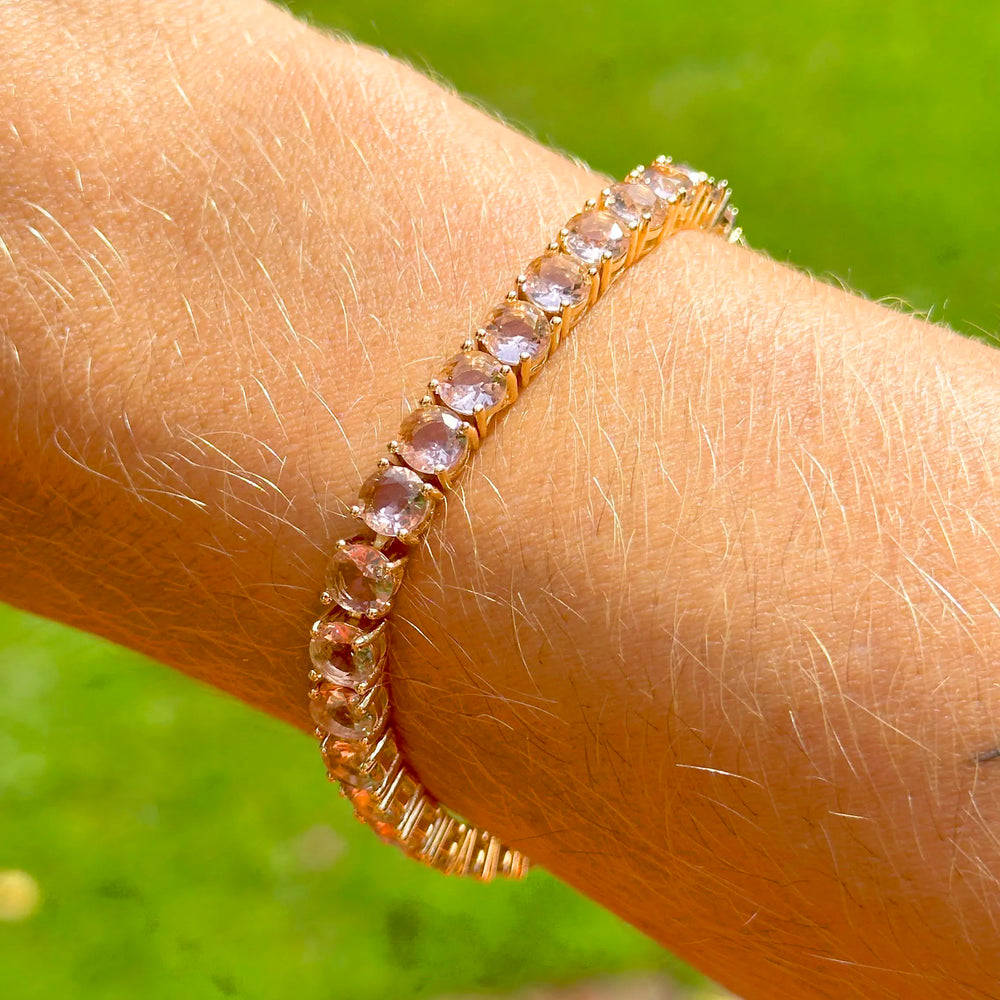 Woman wears Bright Round Rhodolite Crystal Tennis Bracelet, 18k Gold Filled Elladora Store Australia