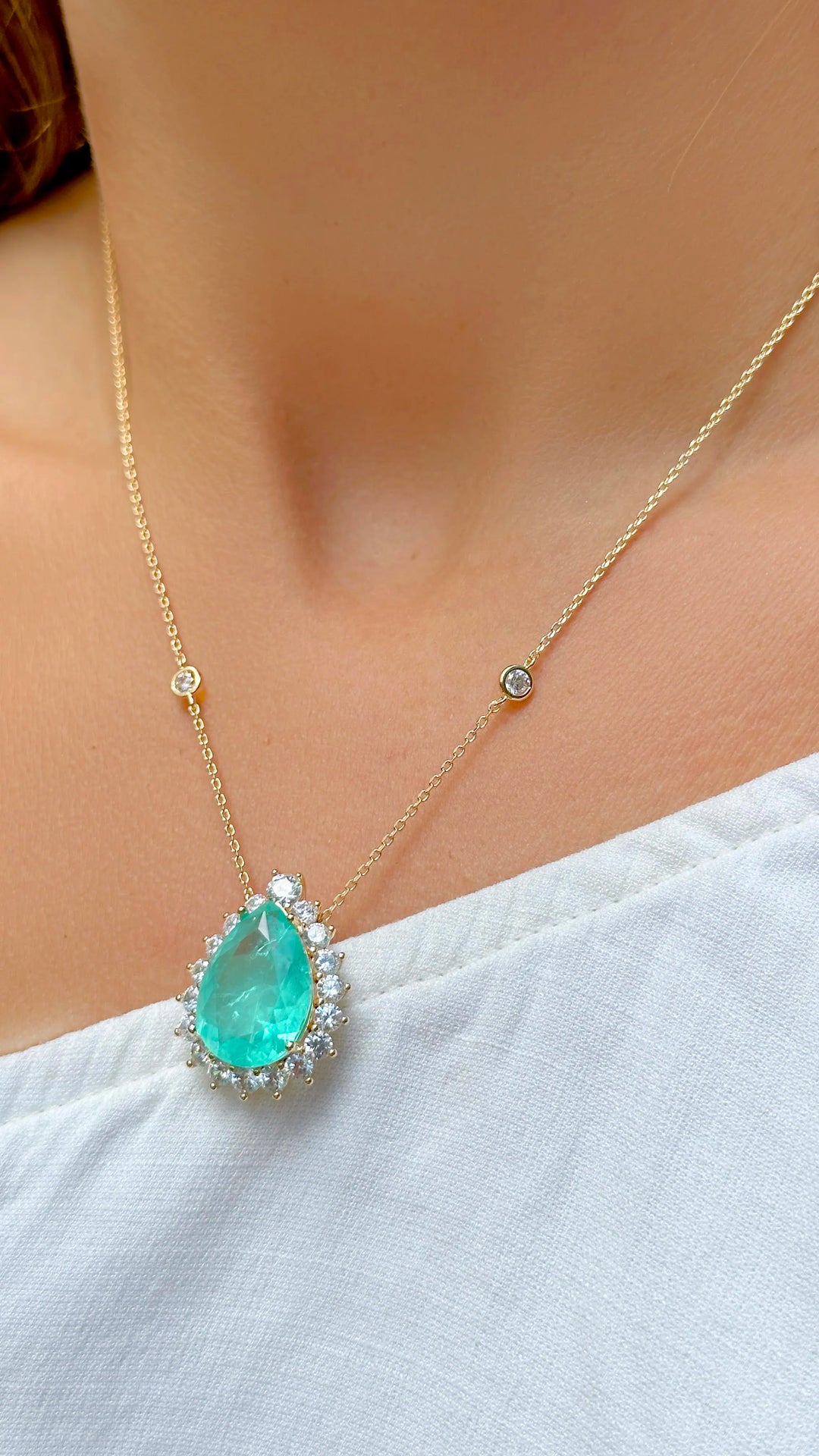 Woman wears Teardrop Colombian emerald pendant necklace with white zirconia 18k gold filled Elladora Store Australia