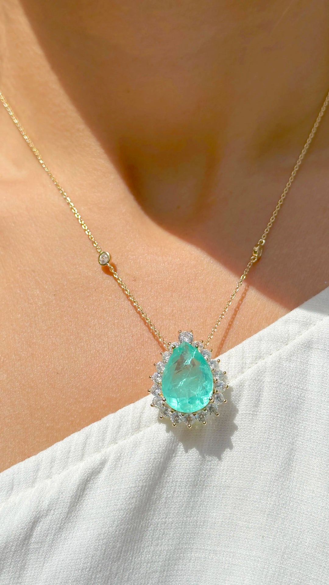 Woman Wears Teardrop Colombian emerald pendant necklace with white zirconia 18k gold filled Elladora Store Australia