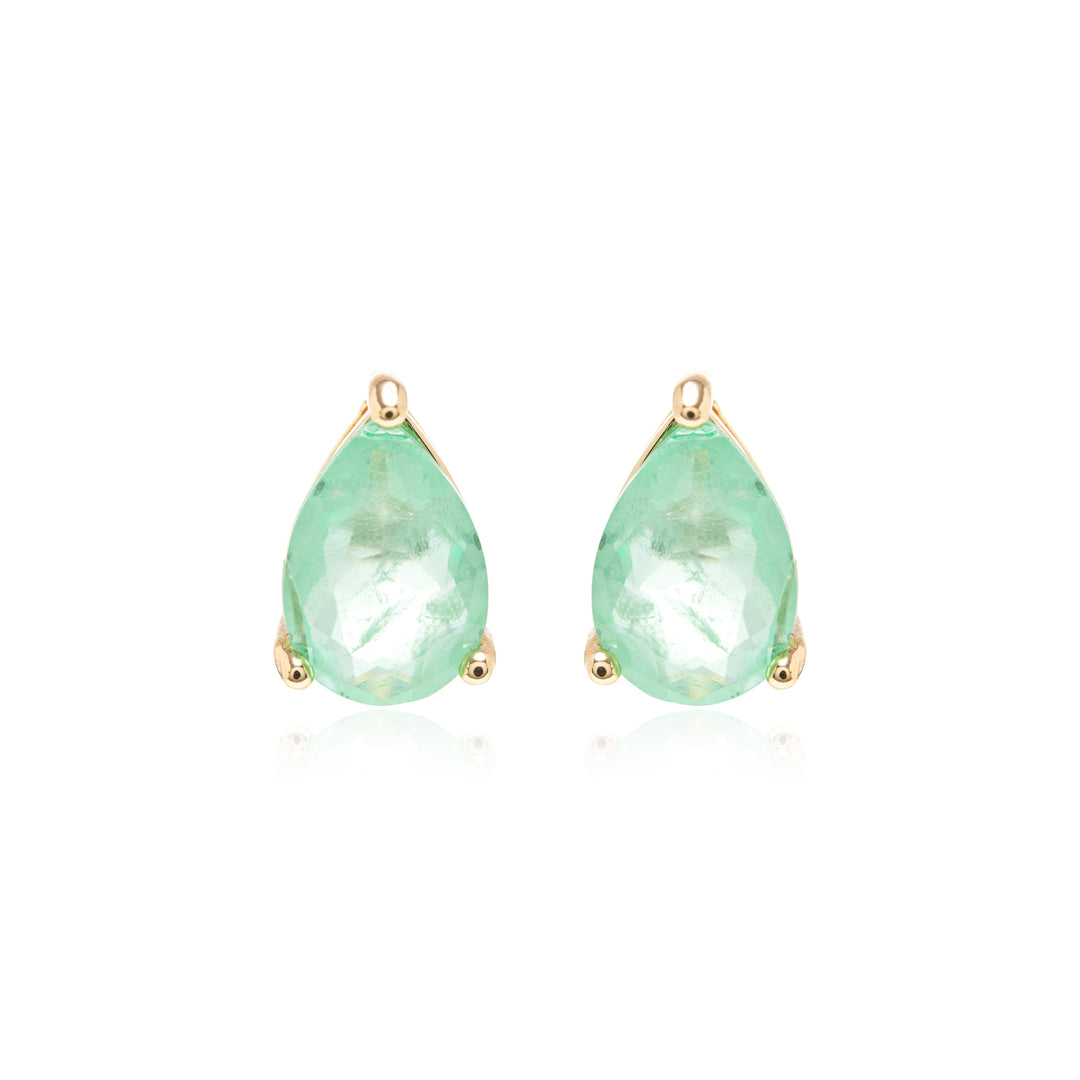 A pair of gold teardrop stud earrings featuring faceted light green gemstones, set against a clean white background with a subtle reflection.