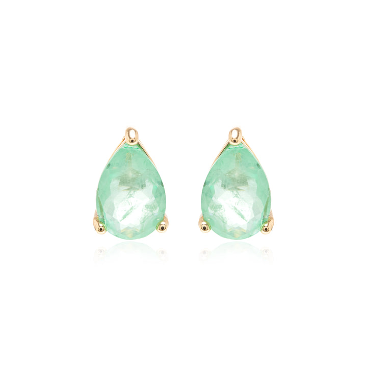 A pair of gold teardrop stud earrings featuring faceted light green gemstones, set against a clean white background with a subtle reflection.