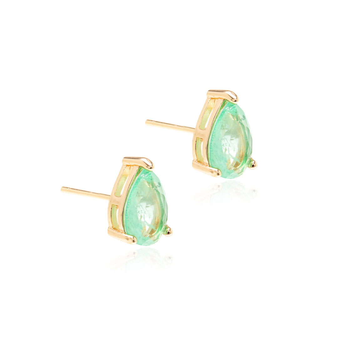 A pair of gold stud earrings featuring teardrop-shaped light green gemstones in a prong setting, displayed on a clean white background with subtle reflections.