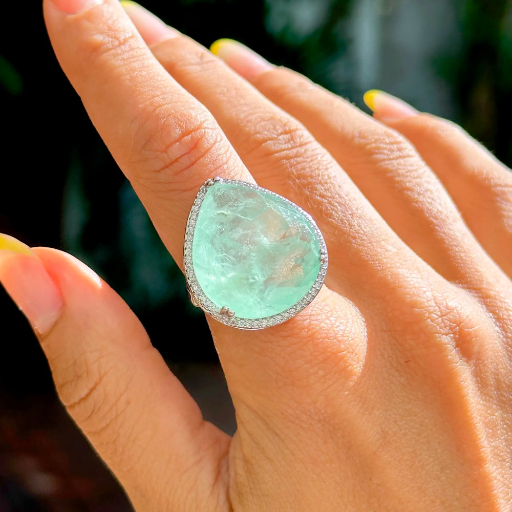 Woman wears Rhodium Plated Drop Colombian Emerald Fusion stone Statement ring with white cubic zirconia  Elladora Store Australia