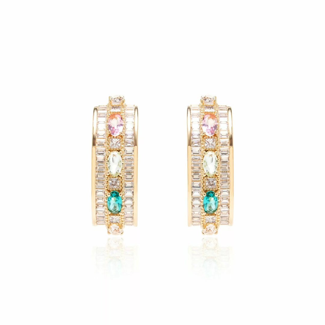 A pair of gold hoop earrings with multiple rows of clear crystals and three colorful gemstone accents in pink, green, and blue, displayed on a clean white background with a soft reflection.