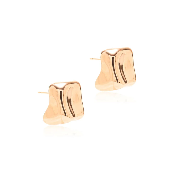 A pair of abstract, organic-shaped gold stud earrings with a polished finish, displayed on a clean white background.