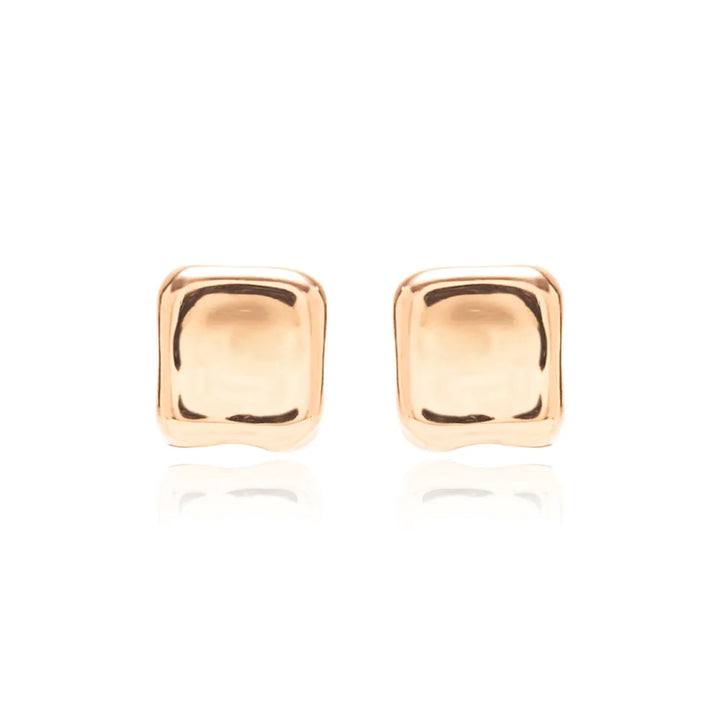 A pair of square stud earrings with a polished, rounded rectangular shape in a warm gold finish, set against a clean white background with a soft reflection below.